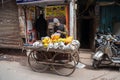 Delhi, India - December 14, 2019: Man sells cantalope, mango and other fruit on his cart along the streets of Old Delhi