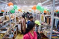 Delhi, India, February 17 2024 - Various age group people reading variety of Books on shelf inside a book-stall at Delhi