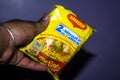 Delhi, India - January 14th 2020: Hand holding brand Maggi instant noodle