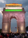 DELHI, INDIA - MARCH 14, 2019: close front view of india gate illuminated with indian flag at dusk in new delhi