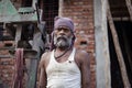 Delhi, India - March 2 2022:- Close up portrait of a labor working on a construction site in new delhi. Labor making a house