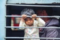 Little child looking from train window at New Delhi train station