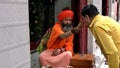 DELHI, INDIA - MARCH 14, 2019: saddhu or hindu holy man places a red dot at old delhi