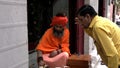 DELHI, INDIA - MARCH 14, 2019: saddhu or hindu holy man places a red dot at old delhi