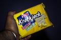 Delhi, India-may 01 2020: Parle Krackjack Biscuits, sweet and salty biscuit in hand