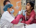 Delhi, India - November 19, 2022 - Close up of female dentist doing routine dental check-up to patient, Patient lying on chair at