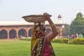 Female worker carries rock waste on her hat in Delhi, India. 2,057  Mio women work in the construction business 2004 and the Royalty Free Stock Photo