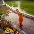 Delhi, India: 13 November 2021- Indian woman celebrating chhath pooja by submerging in the water, indian woman wearing traditional