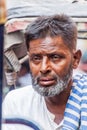 DELHI, INDIA - OCTOBER 22, 2016: Face of a tired cyclo rickshaw driver in the center of Delhi, Indi