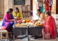 Hindu women weaving flower garlands at ISKCON Delhi Hindu temple