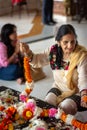 Hindu women weaving flower garlands at ISKCON Delhi Hindu temple Royalty Free Stock Photo