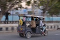 Delhi, India, 2020.Panning shot of a speeding e- rickshaw on Delhi roads. Electric rickshaws are economical mode of transportation Royalty Free Stock Photo
