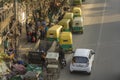 Parking Indian rickshaws near garbage cans and sidewalk aerial view