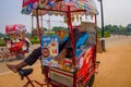 DELHI, INDIA - SEPTEMBER 26, 2017: Colorful carts sell drinks and ice creams clustered around India Gate in Delhi, India