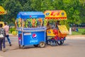 Delhi, India - September 16, 2017: Colorful carts sell drinks and ice creams clustered in the streets in Delhi, India