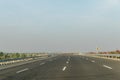 Delhi-Mumbai Expressway with mountain and greenery views on each side of road