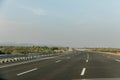 Delhi-Mumbai Expressway with mountain and greenery views on each side of road