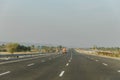 Delhi-Mumbai Expressway with mountain and greenery views on each side of road