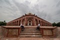 Delhi, New Delhi/ India- May 30 2020: Two old aged people sitting in the compound of Humayun's Tomb having a conversation,