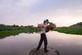 Delhi, New Delhi, India, September 6 2021: Unidentified fisherman throwing his fishnet into the lake with great force to catch Royalty Free Stock Photo