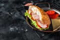 Deli meat sandwich with turkey ham, cheese, tomato and Lettuce. Black background. Top view. Copy space Royalty Free Stock Photo