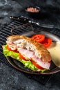 Deli meat sandwich with turkey ham, cheese, tomato and Lettuce. Black background. Top view Royalty Free Stock Photo