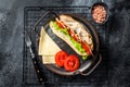 Deli meat sandwich with turkey ham, cheese, tomato and Lettuce. Black background. Top view Royalty Free Stock Photo