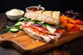 deli meat sandwich with vegetables and mayo on a crusty baguette Royalty Free Stock Photo