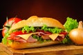 Deli sub sandwich and vegetables Royalty Free Stock Photo