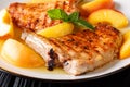 Delicacies: the grilled pork chop is served with glazed peaches Royalty Free Stock Photo