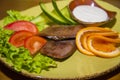 Delicacy beef tongue with fresh vegetables.