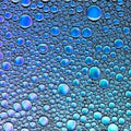 Delicate abstract blue background from drops of oil and water. Beautiful art backdrop. Macro of colored bubbles Royalty Free Stock Photo