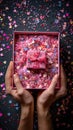 Delicate Affection Gentle Hands Embrace a Pink Box Filled with Heart-Shaped Confetti