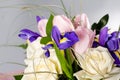 Delicate beautiful bouquet of iris, roses and other flowers on gray background Royalty Free Stock Photo