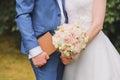 Delicate beautiful wedding bouquet of pink peony roses and orchids in the hands of the bride, in the hands of the groom brown book Royalty Free Stock Photo