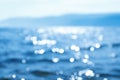 Delicate blue texture bokeh sea background. blurry blue bokeh glare on the water on a sunny day. rest and travel Royalty Free Stock Photo