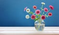 Delicate bouquet with pink zinnias on a blue background