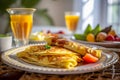Delicate crepes, fresh fruits, and a glass of refreshing orange juice create a colorful and enticing morning scene