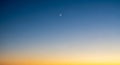 Crescent Moon in a Gradient Sky of Blue and Orange at Twilight dusk Royalty Free Stock Photo