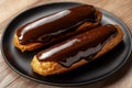 Delicate Eclair With Glossy Chocolate Glaze on a Sleek Black Plate Generative AI Royalty Free Stock Photo