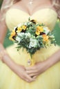 A delicate and elegant bride`s bouquet of yellow-purple pansies