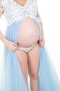 Delicate elegant pregnant woman in a white blue dress