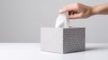 Delicate female hand pulling a tissue from a grey tissue box, on simple background. Generative AI Royalty Free Stock Photo