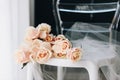 Delicate feminine picture of beautiful bouquet of roses on a chair with tulle sheer fabric, closeup or close-up Royalty Free Stock Photo