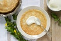 Delicate fishnet pancakes with sour cream.