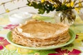 Delicate fishnet pancakes with sour cream.