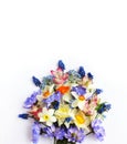 Delicate floral arrangement - spring yellow and purple flowers on a white background.