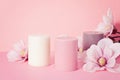 Delicate flower scented candle over pastel pink background