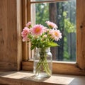 Delicate flowers in a glass vase illuminated by the soft light from the window. Royalty Free Stock Photo