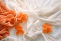 Delicate flowers and petals on a bed of light satin fabric with soft folds and a silky texture